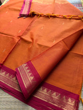 Orange shade with contrast small maroon zari small Thazhampoo border Kanchi cotton saree with rich Zari woven Pallu & hand made Zari Buttas