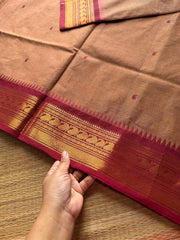 Biscuit shade Kanchi cotton saree with contrast Zari border & handmade thread buttas