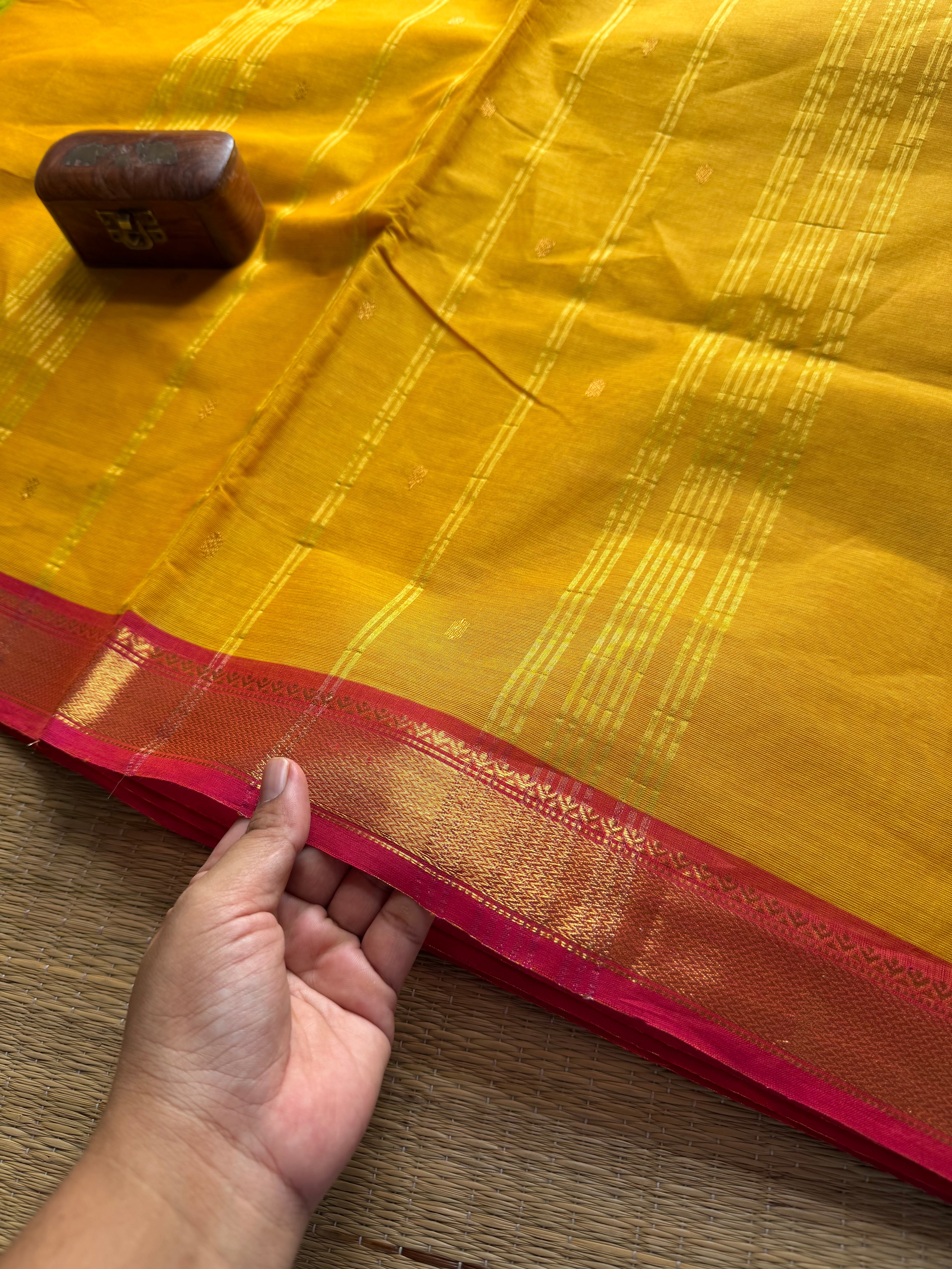 Mustard yellow with pinkish peach combination small border Kanchi cotton saree with handmade golden Zari Buttas
