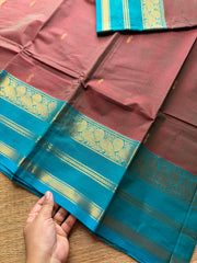 Unique and dual shade Kanchi cotton saree with contrast sky blue border and handmade golden Zari Buttas