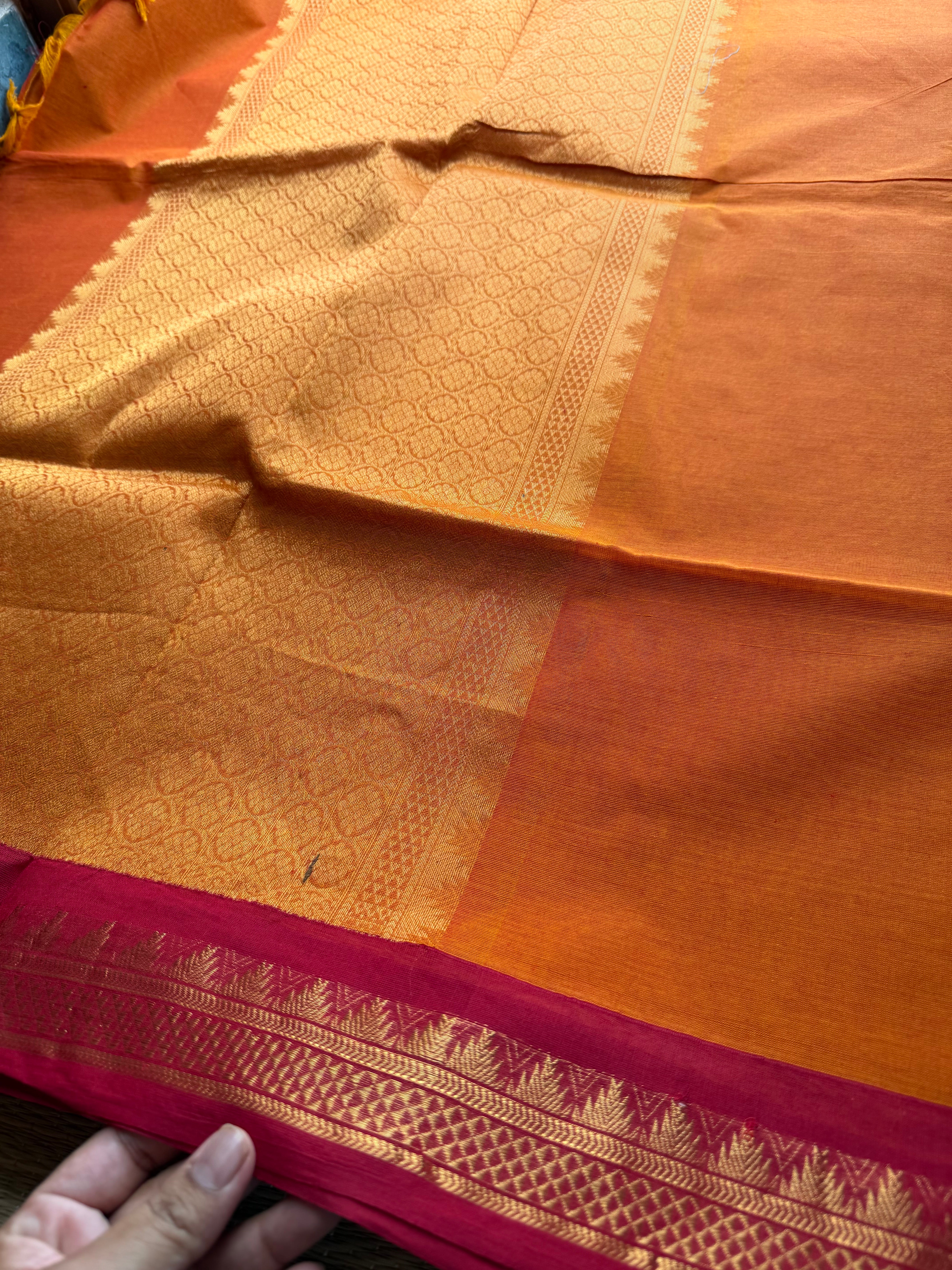 Orange shade with contrast small maroon zari small Thazhampoo border Kanchi cotton saree with rich Zari woven Pallu & hand made Zari Buttas