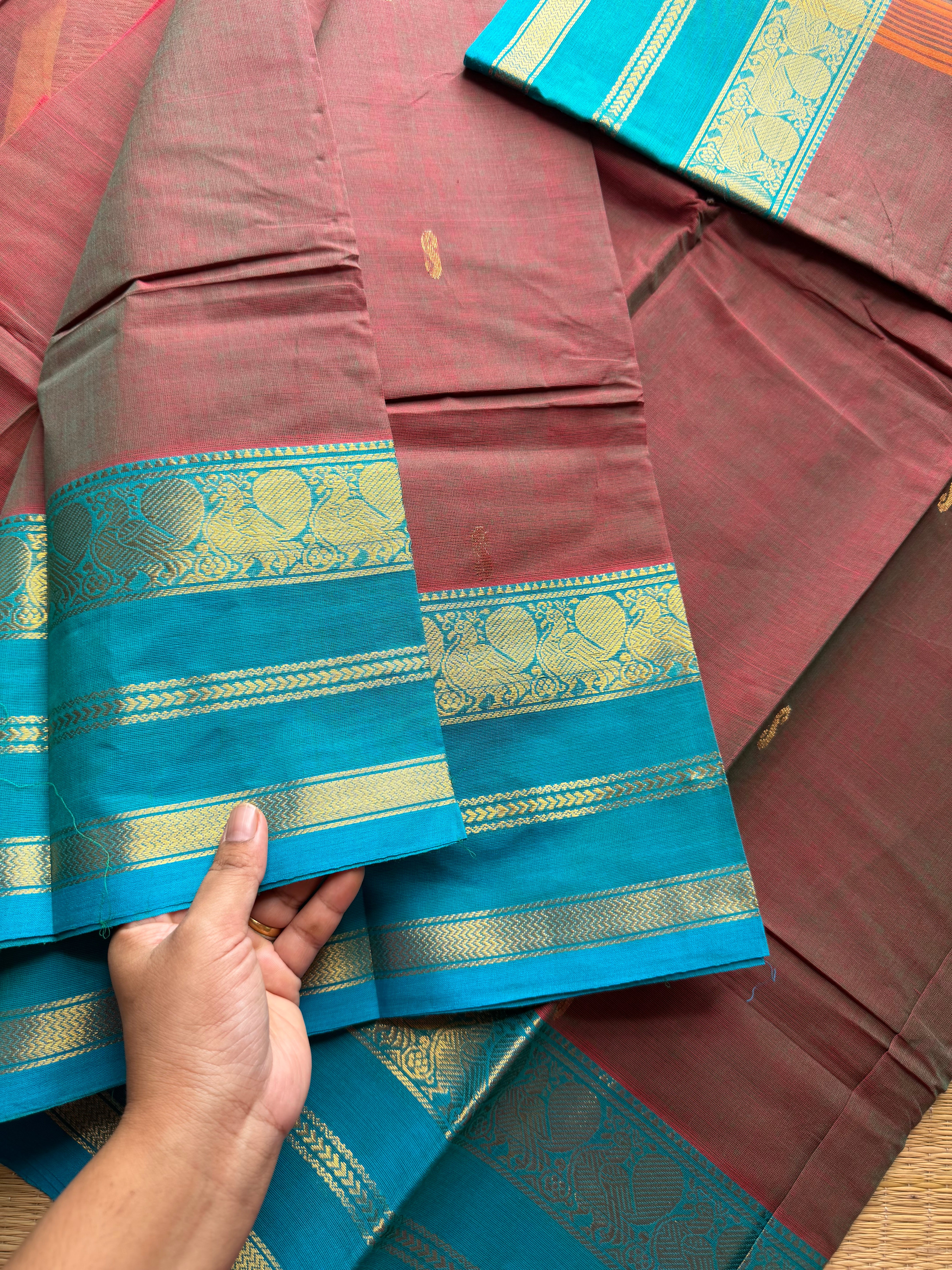 Unique and dual shade Kanchi cotton saree with contrast sky blue border and handmade golden Zari Buttas