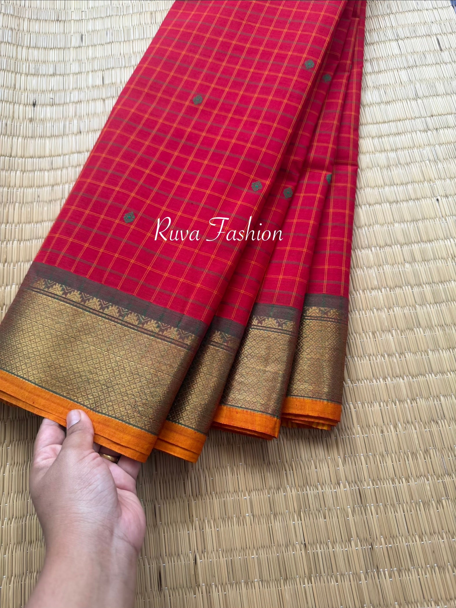 RF137 Chilli red Kanchi cotton saree featuring a classic checks (kattam) pattern, with elegant handmade thread buttas and contrast Zari border with small Thazhampoo pattern