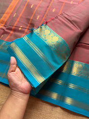 Unique and dual shade Kanchi cotton saree with contrast sky blue border and handmade golden Zari Buttas