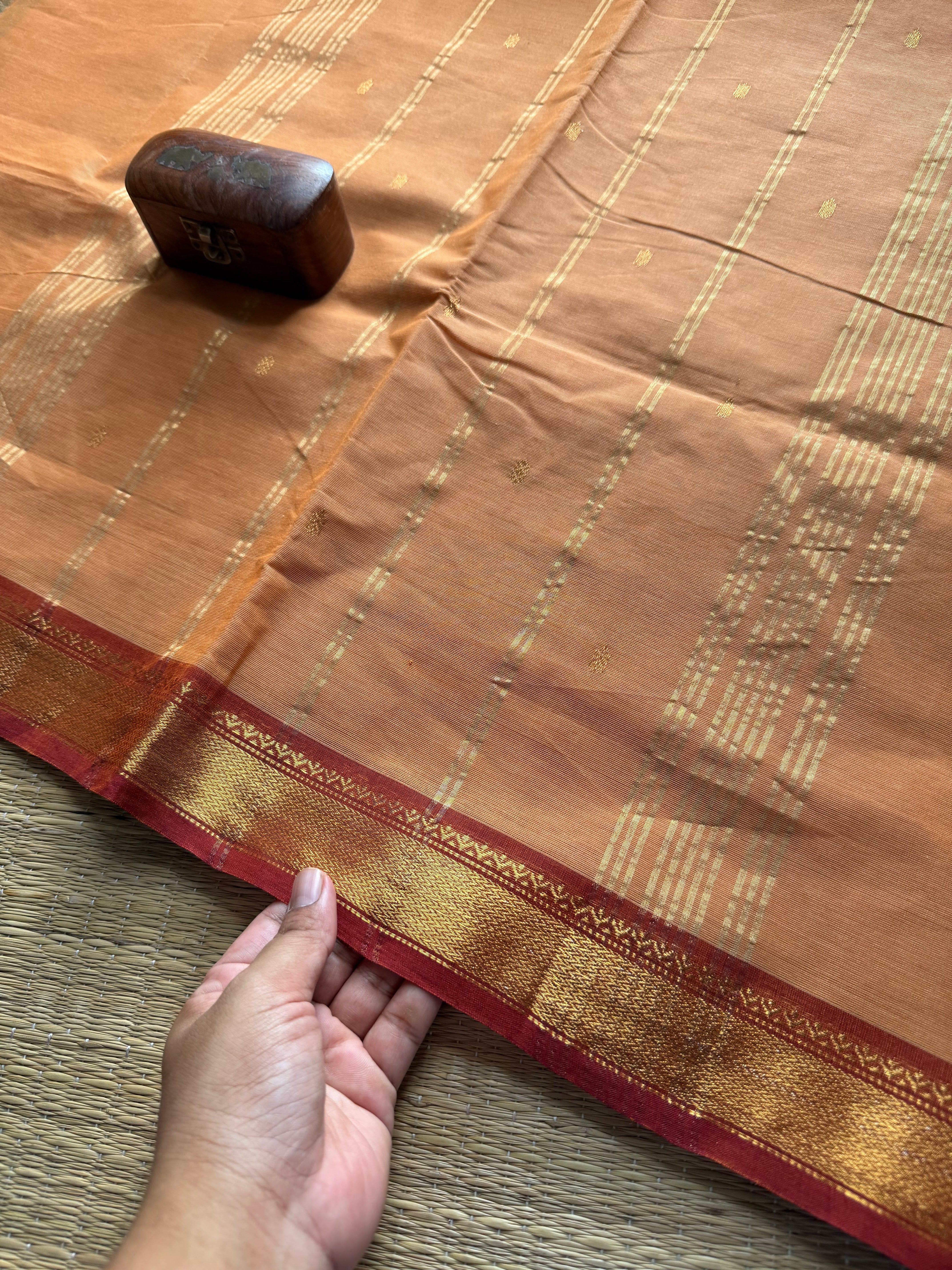 Beige shade small border Kanchi cotton saree with handmade golden Zari Buttas