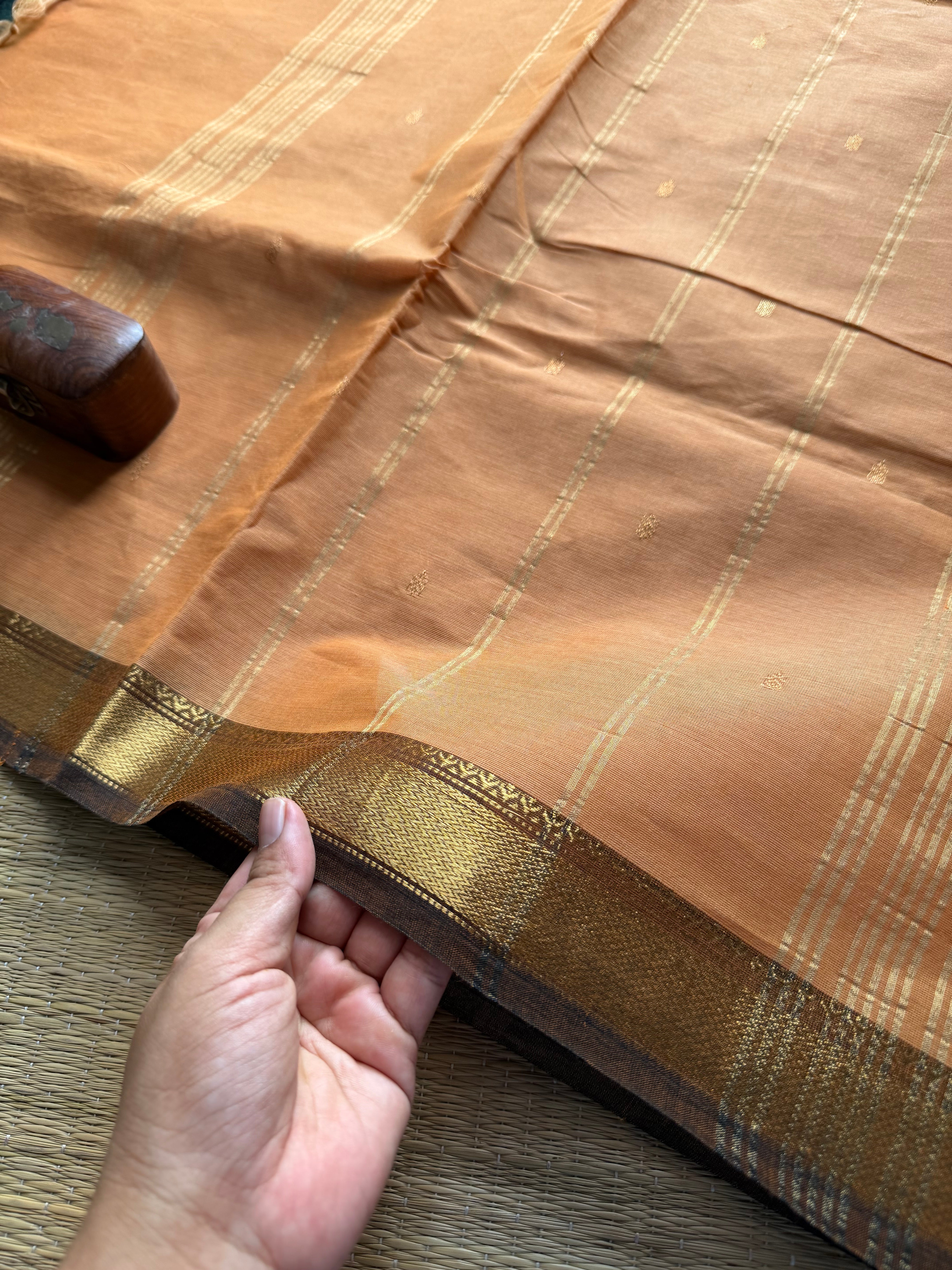 Beige shade small border Kanchi cotton saree with handmade golden Zari Buttas