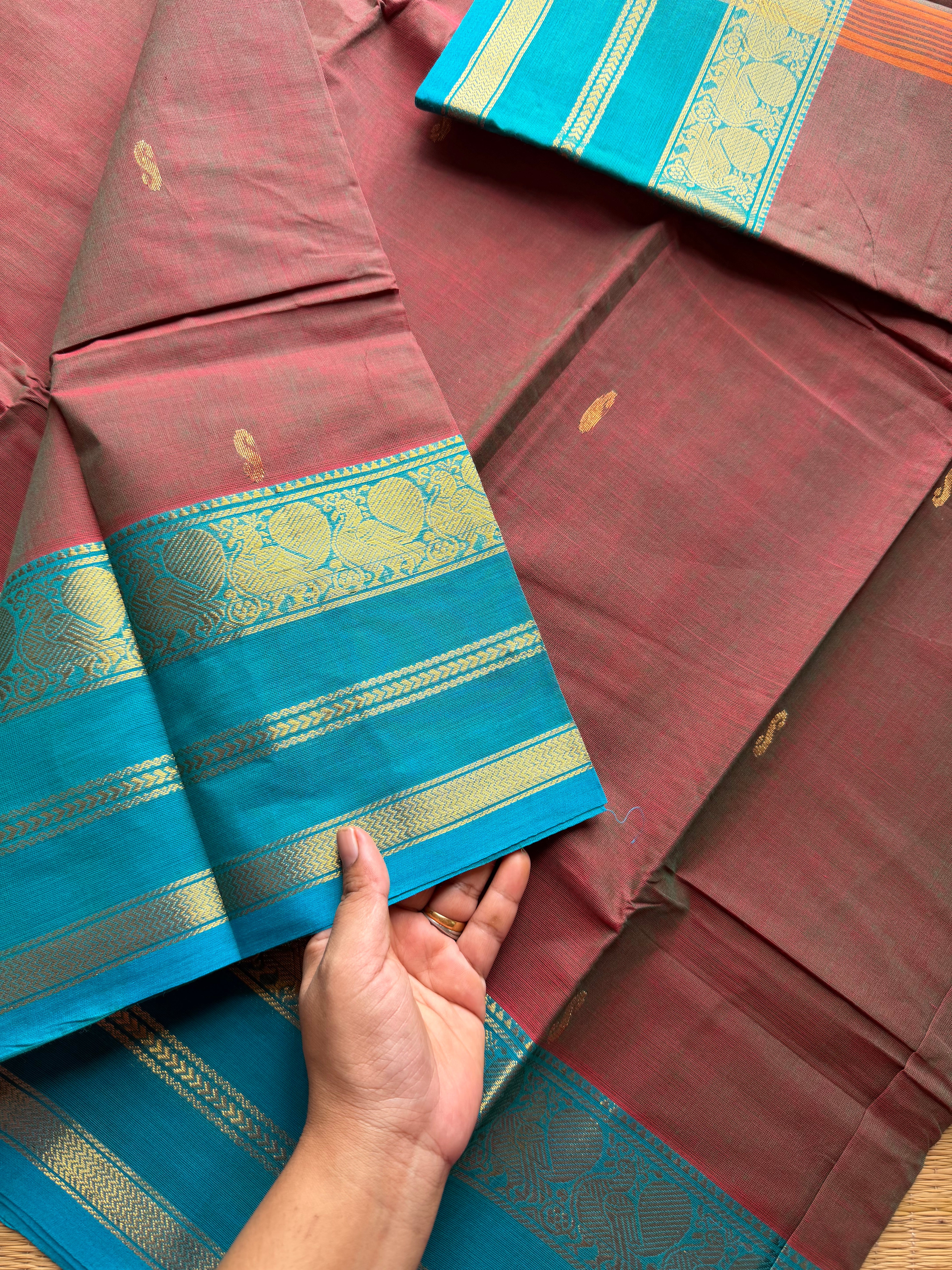 Unique and dual shade Kanchi cotton saree with contrast sky blue border and handmade golden Zari Buttas