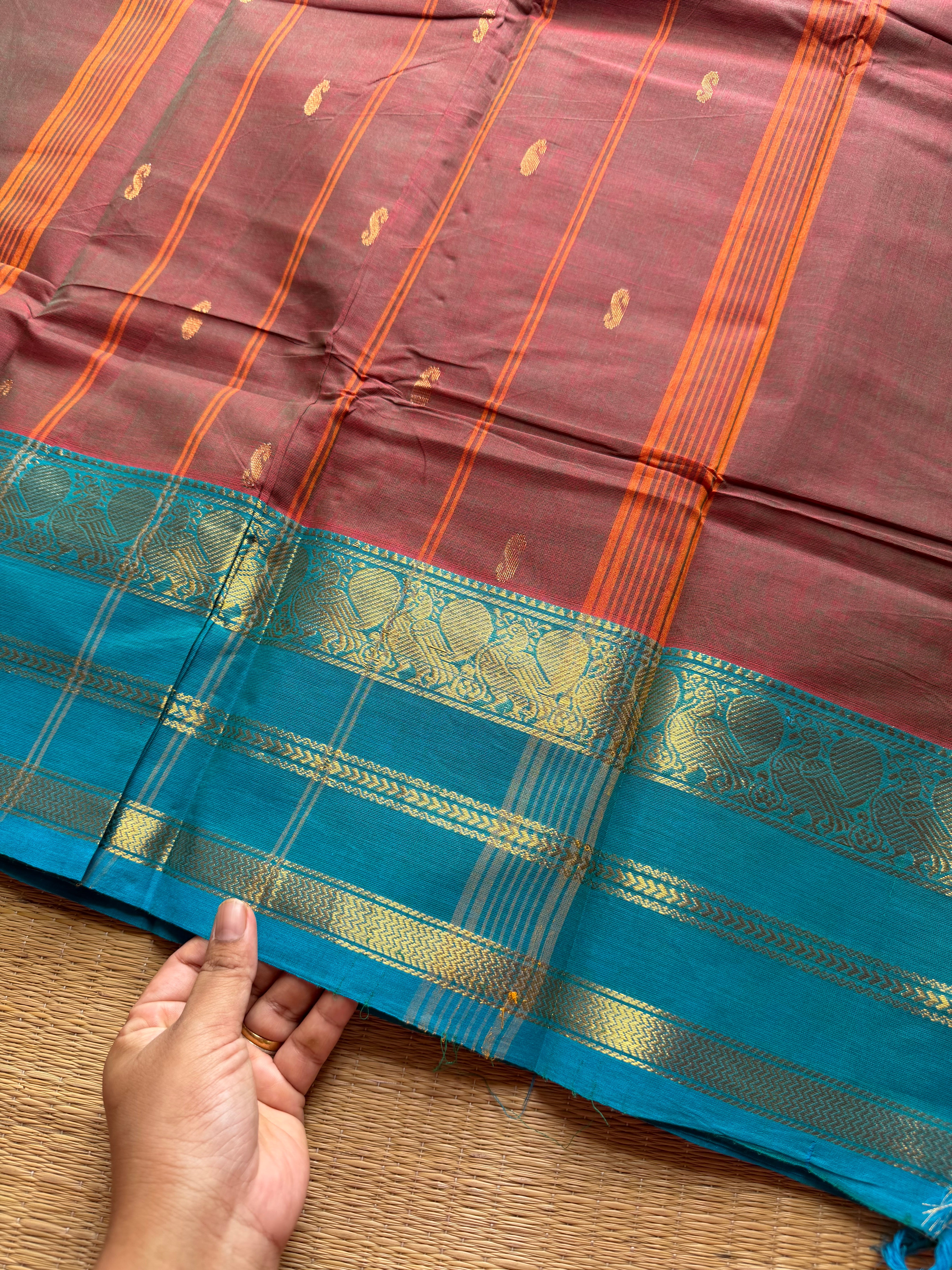 Unique and dual shade Kanchi cotton saree with contrast sky blue border and handmade golden Zari Buttas