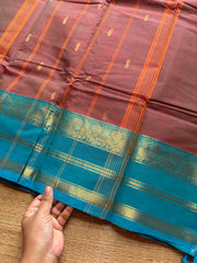 Unique and dual shade Kanchi cotton saree with contrast sky blue border and handmade golden Zari Buttas