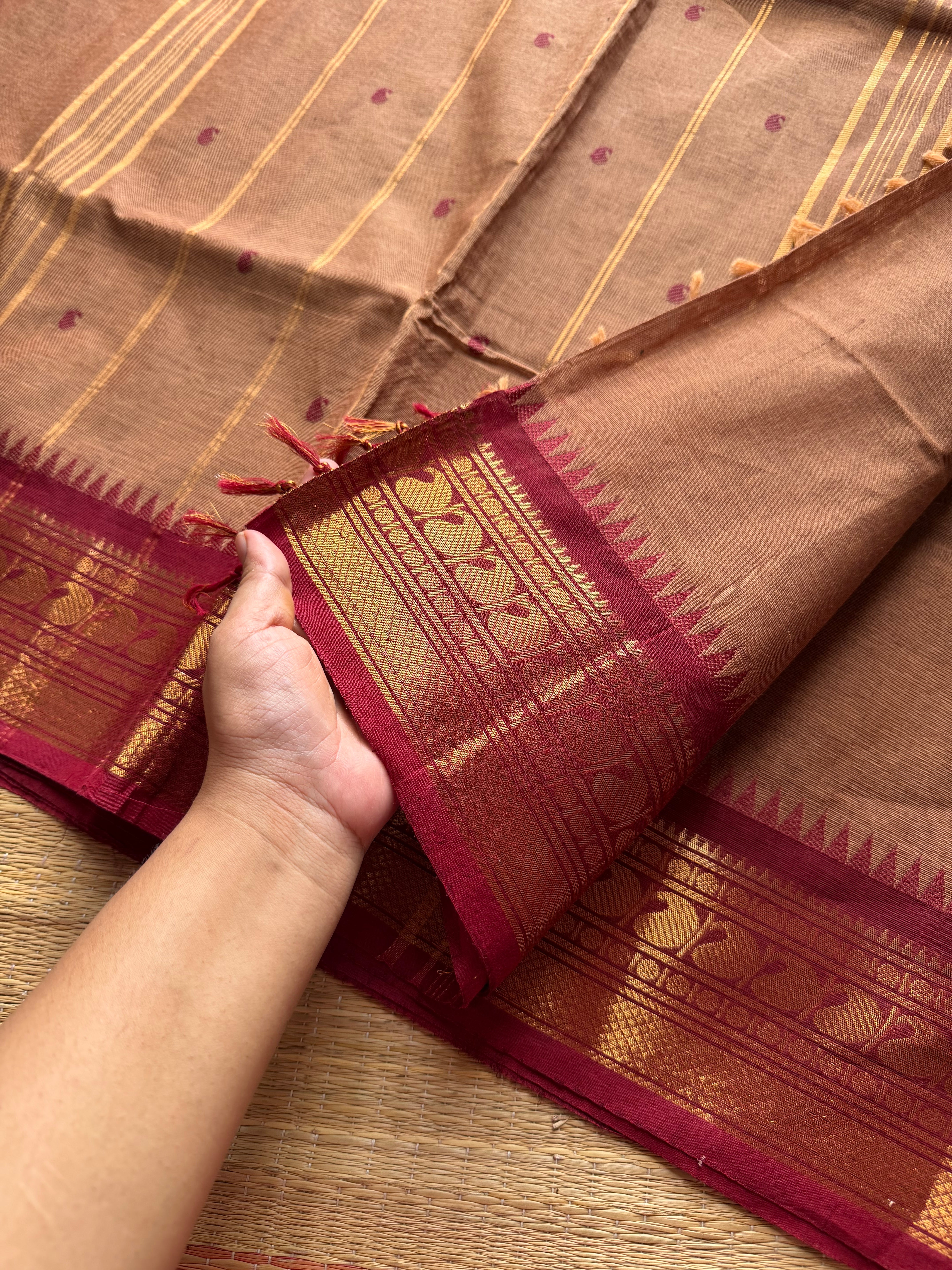 Biscuit shade Kanchi cotton saree with contrast Zari border & handmade thread buttas
