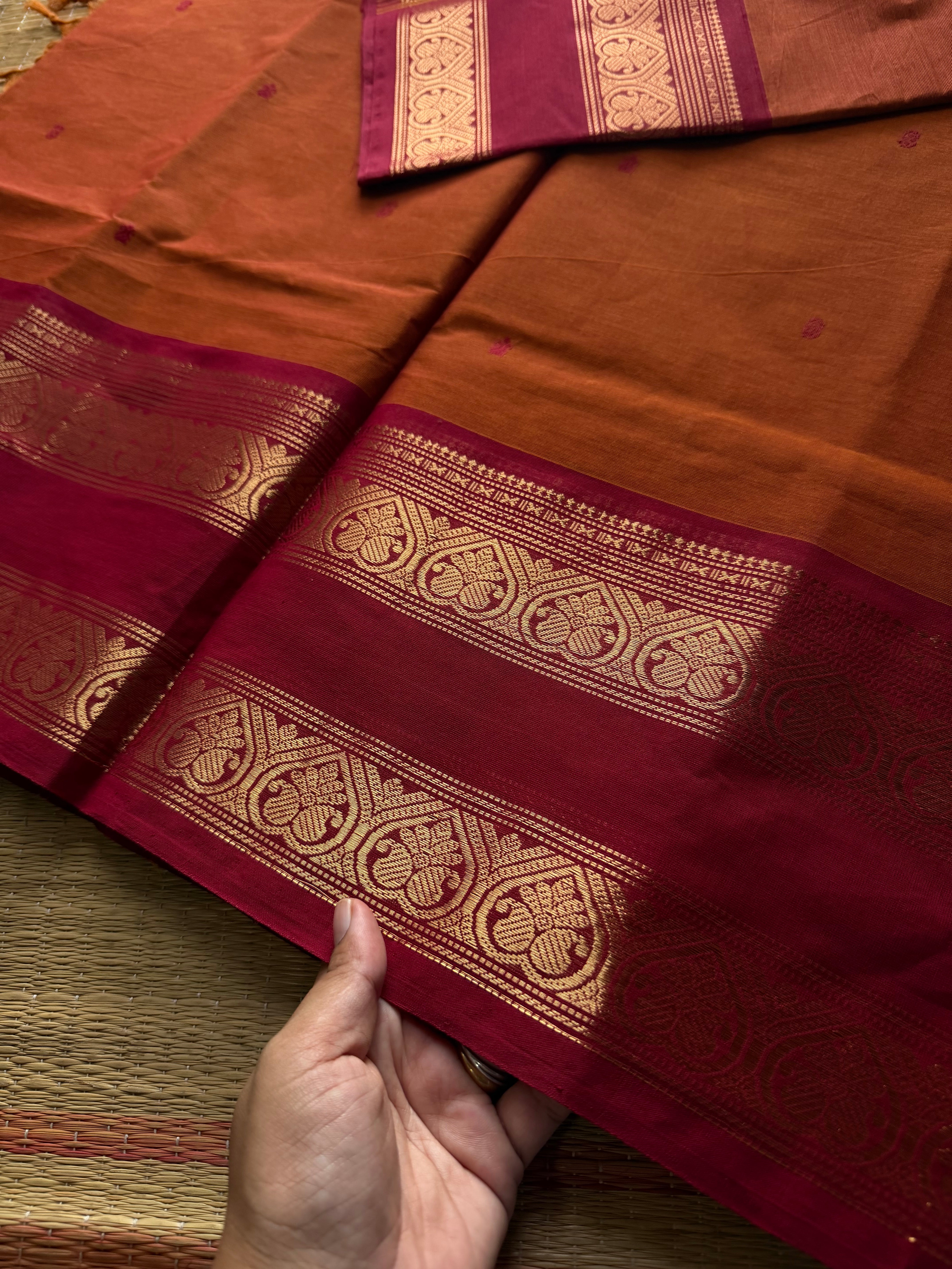 Orange shade Kanchi cotton saree with handmade thread buttas