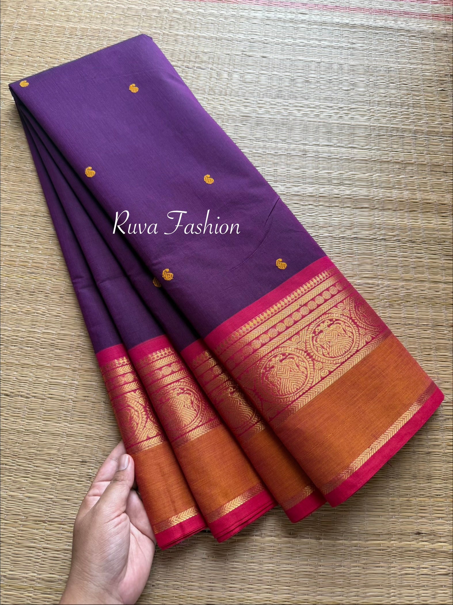 Purple shade Kanchi cotton saree with contrast red and orange combination with handmade thread buttas