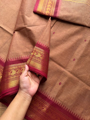 Biscuit shade Kanchi cotton saree with contrast Zari border & handmade thread buttas