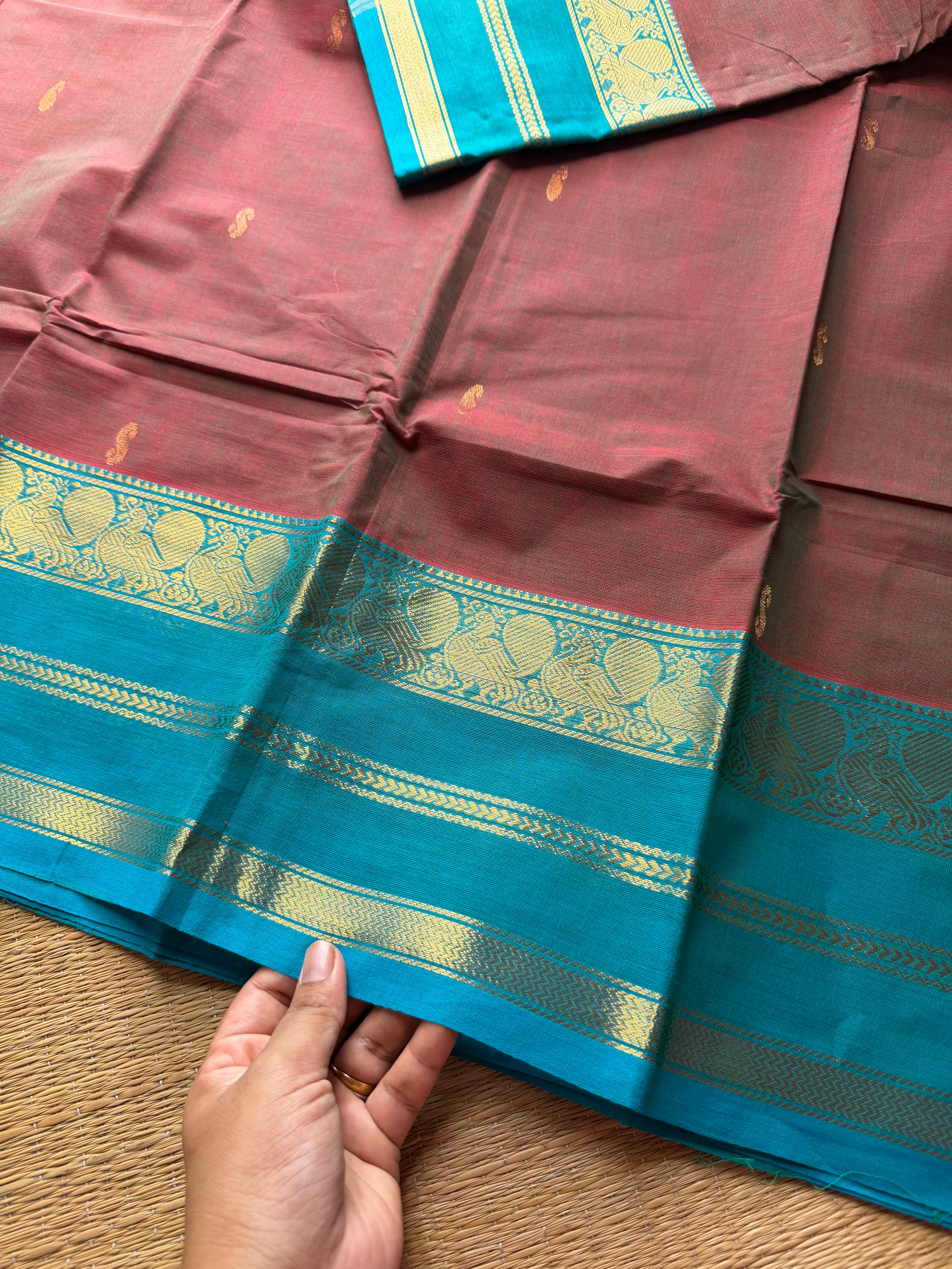 Unique and dual shade Kanchi cotton saree with contrast sky blue border and handmade golden Zari Buttas