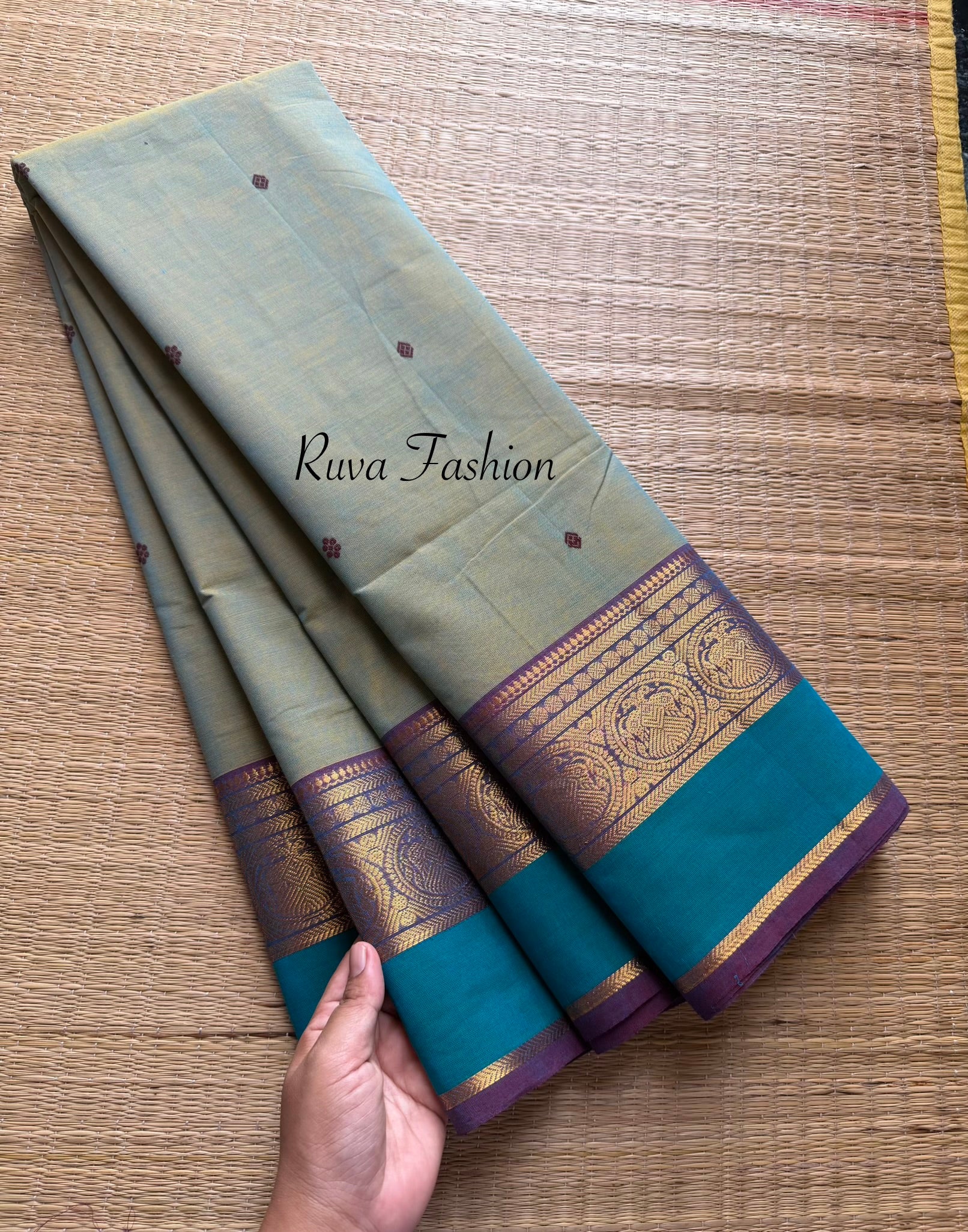 Dual shade of light dusty olive shade Kanchi cotton saree with contrast border and handmade thread buttas
