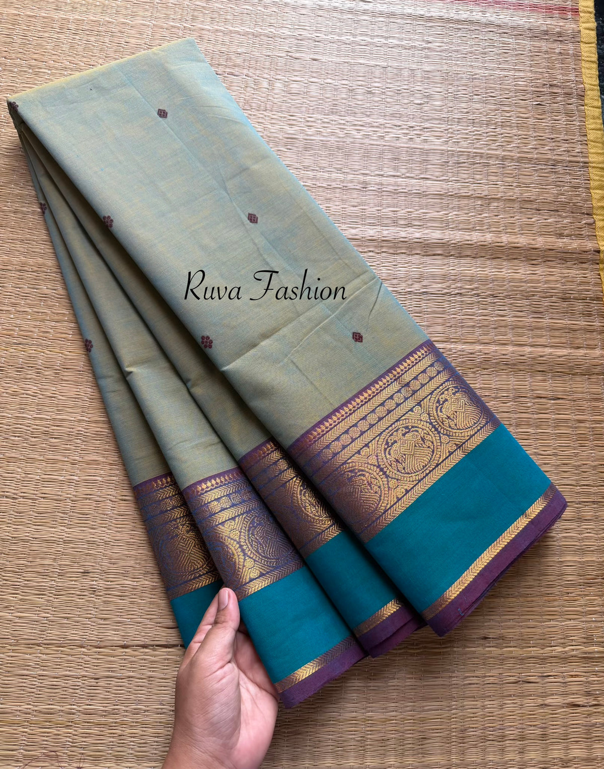 Dual shade of light dusty olive shade Kanchi cotton saree with contrast border and handmade thread buttas